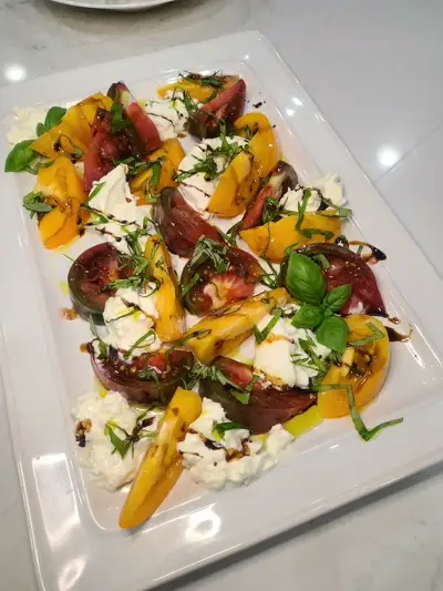 Heirloom tomato and burrata caprese salad with vibrant colors, prepared by Chef Mollie in Nashville