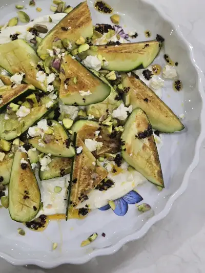 Grilled zucchini with crumbled feta and toasted pistachio — a light summer dish by Chef Mollie